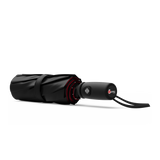 An image of a closed, black and red colored travel Repel umbrella. 