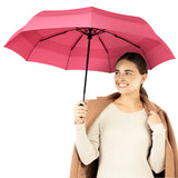 Woman holding Repel's best-selling windproof pink travel compact umbrella.