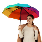 Woman holding Repel's best-selling windproof rainbow travel compact umbrella