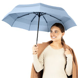 A woman holding the slate blue travel compact umbrella that is windproof and best selling from Repel Umbrella