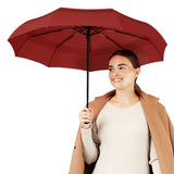 Woman holding Repel's best-selling windproof red travel compact umbrella.